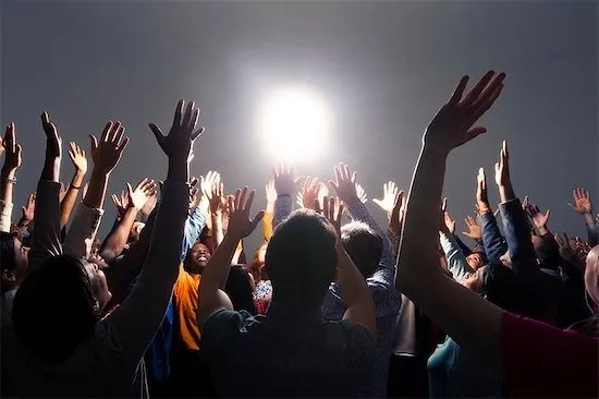 Group of people raising their hands