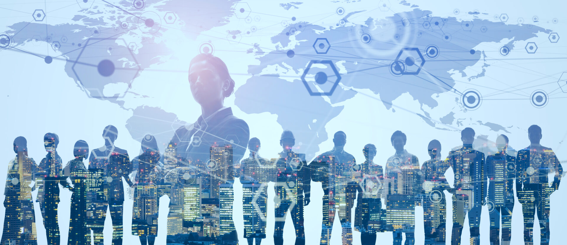 Silhouettes of business people standing in front of a world map.