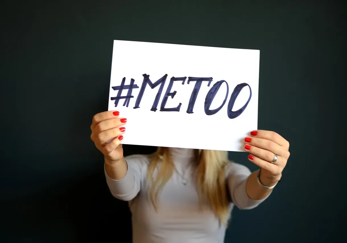 A woman holding the banner of “#MeToo”