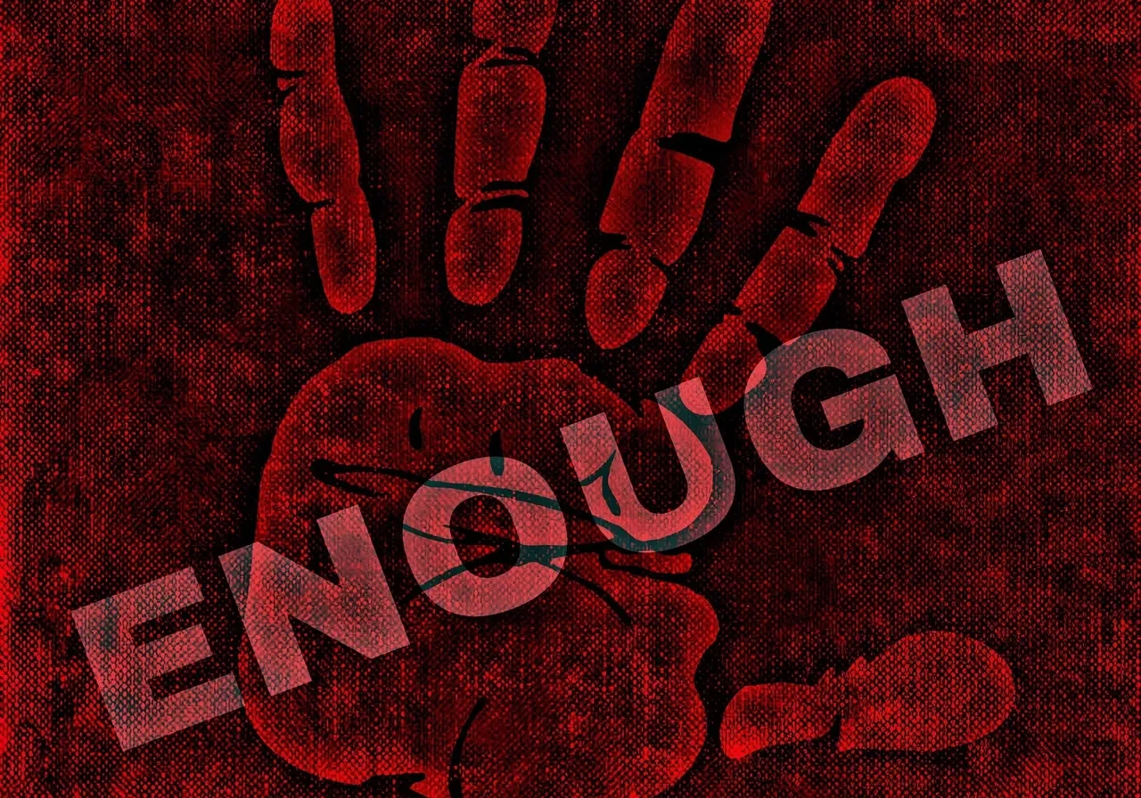 A handprint with the word “Enough” written in red color